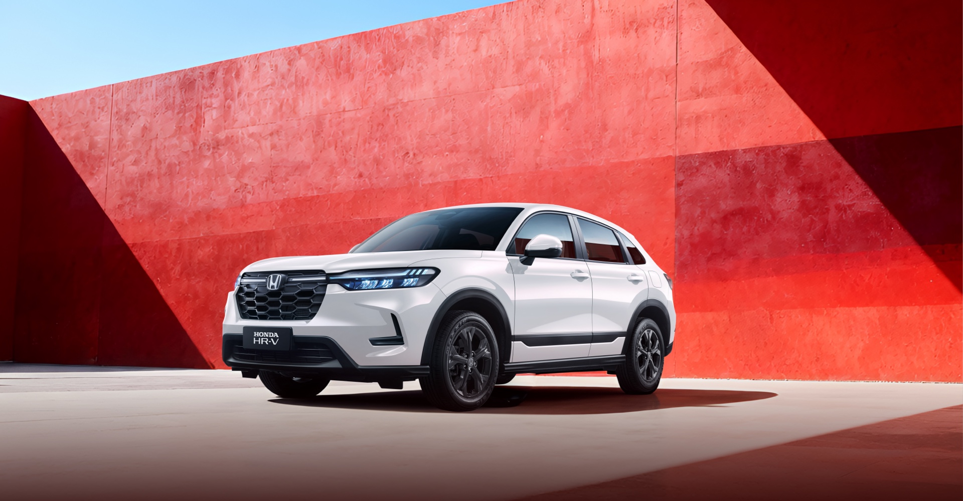Front view of the 2026 HONDA HR-V, white body against red background