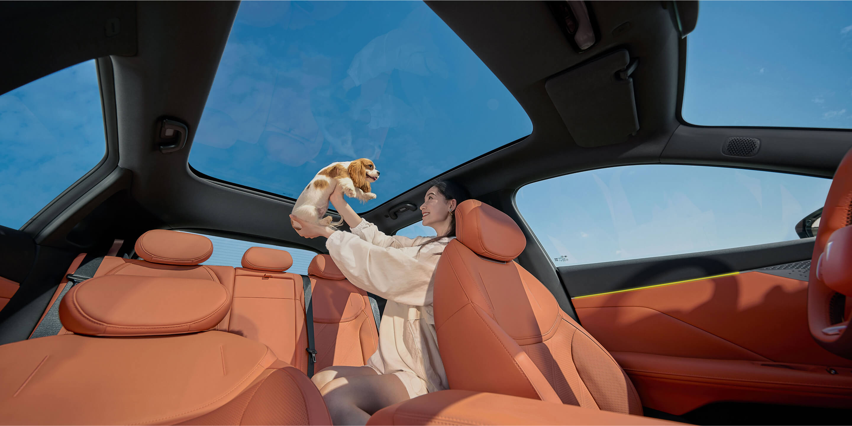 Interior photo of the 2026 Deepal S05 in orange, set against an outdoor natural backdrop.