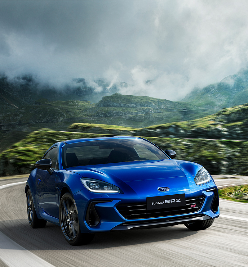 Blue 2026 Subaru SUBARU BRZ STI Sport coupe driving on a mountain highway