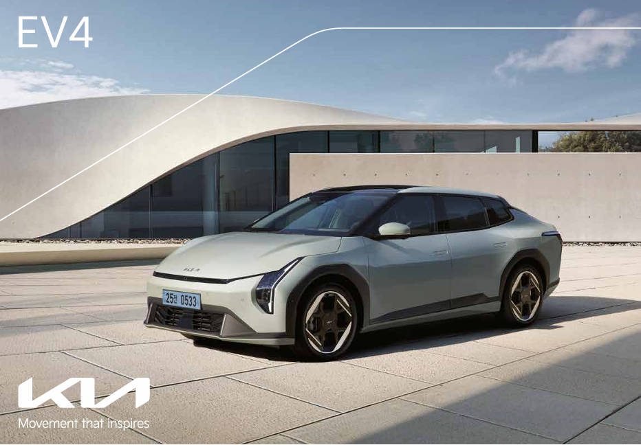Right-side view of the 2026 KIA EV6, silver body, backdrop of TownCar skyscrapers